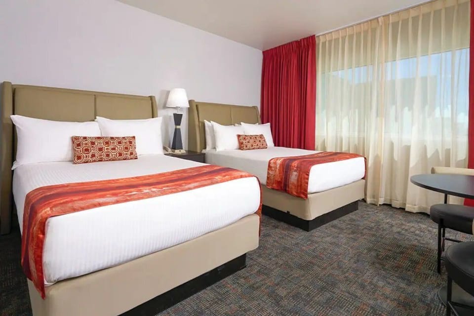 Relax in a bright, airy room with soft drapes.