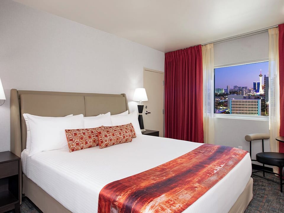 Wake up to skyline views from a plush king bed.