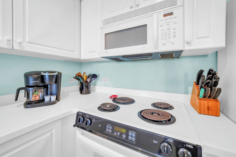 Your fully equipped kitchen awaits with modern appliances, fresh coffee maker, and quality cookware ready for memorable meals.
