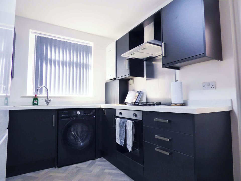Kitchen: Modern appliances and sleek design make cooking a delight during your stay!