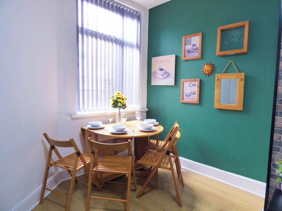 Dining Nook: Enjoy delightful meals in this charming space with pops of green and natural light!