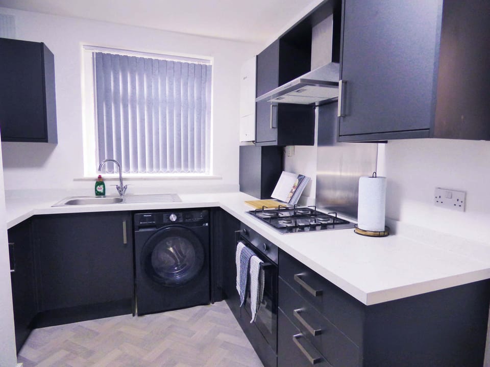Modern Kitchen: Whip up culinary delights in this sleek, well-equipped space with ample light!