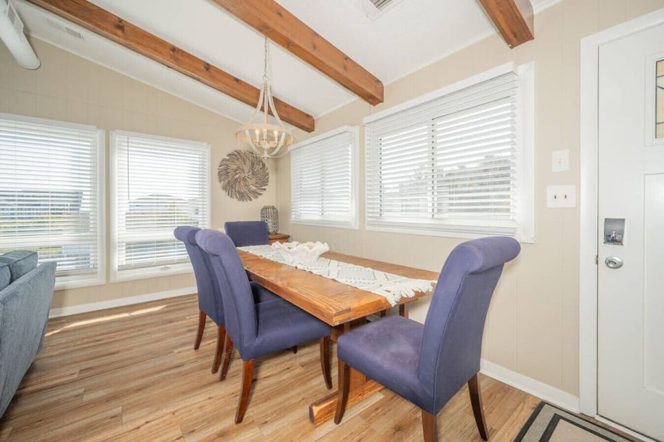 Charming dining space with exposed beams and natural light—perfect for shared meals and gathering together.