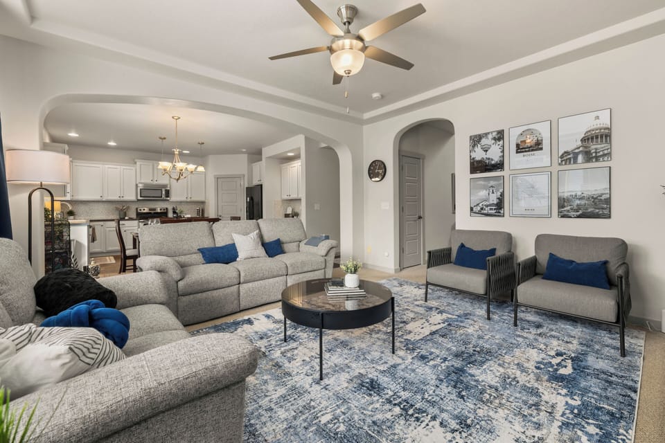 Spacious open concept with cozy seating, where kitchen, dining, and living spaces flow seamlessly