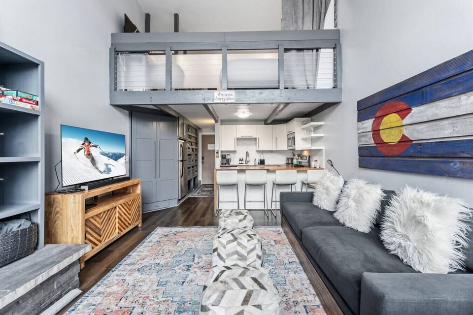 Sun-lit living room with sofa bed and smart TV