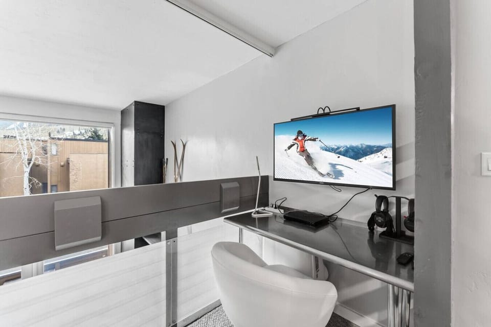 Primary bedroom in loft with king bed and workspace