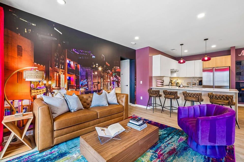 Open concept features a comfortable living space with sofa bed, fully equipped kitchen, Smart TV, patio access, and incredible photo-ops from every angle.