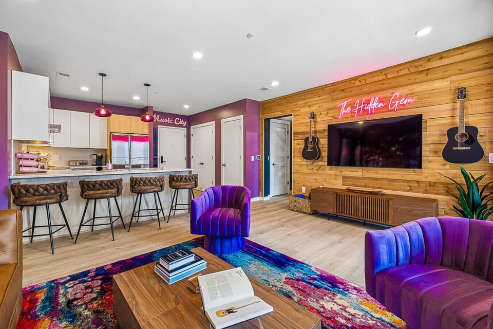 Open concept features a comfortable living space with sofa bed, fully equipped kitchen, Smart TV, patio access, and incredible photo-ops from every angle.