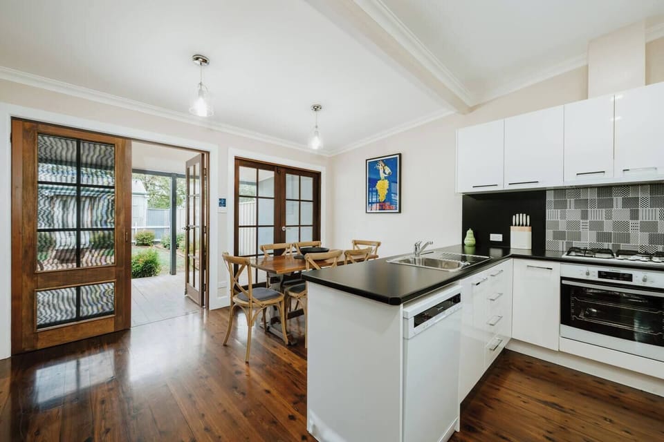 An open-plan kitchen and dining area creates an easy space for cooking, gathering and shared meals.