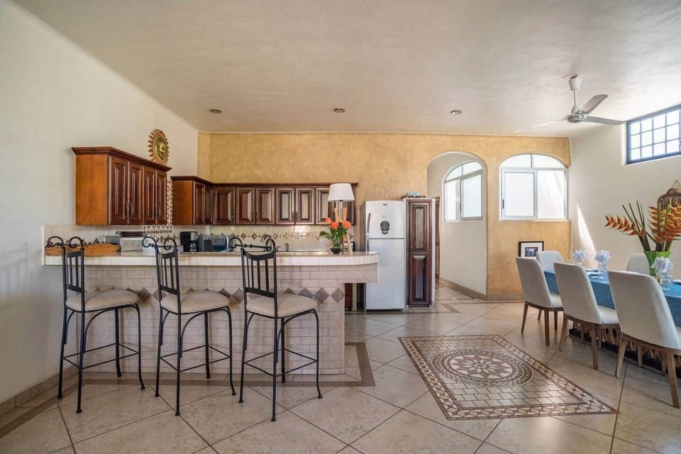 SECOND FLOOR: Spacious kitchen with eat in counter for three and, dining area with big table seating for eight 