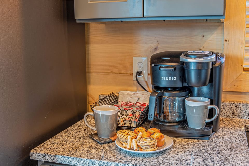 Coffee station with Keurig, drip coffee, French press, and hot cacao.