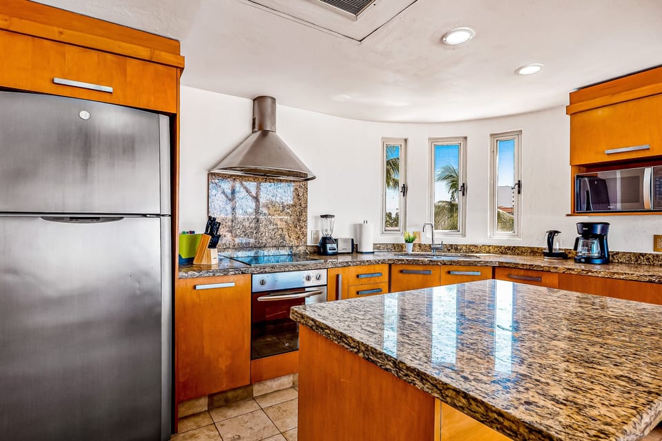 Cook with ease in the modern kitchen featuring stainless steel appliances, granite countertops, and everything needed for home-cooked meals.