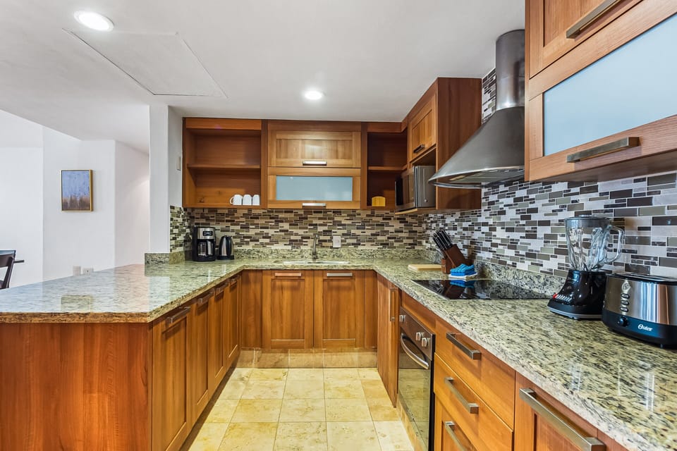 Enjoy a spacious modern kitchen with ample counter space, upgraded appliances, and everything needed for cooking during your beach getaway.