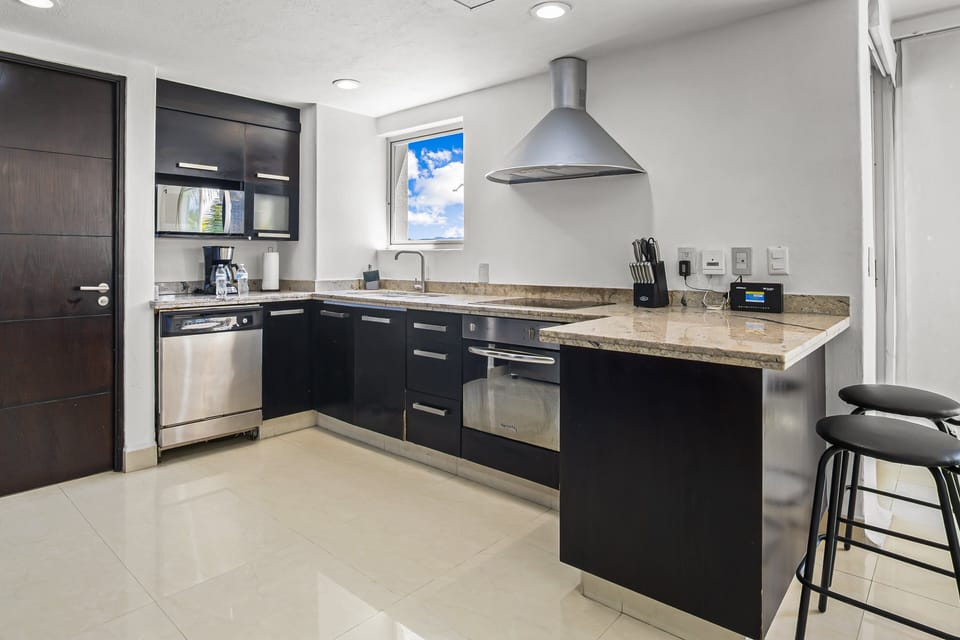 Cook with ease in the stylish kitchen featuring modern appliances, spacious countertops, and everything needed for preparing meals during your stay.