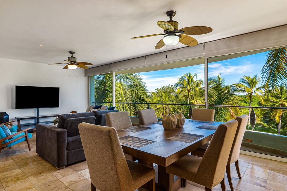 Enjoy breathtaking tropical views from a bright open-concept living and dining area designed for relaxing, entertaining, and coastal comfort.
