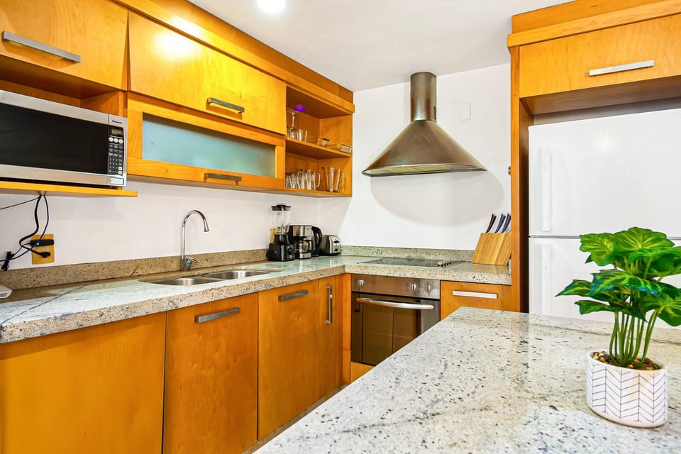 Prepare meals with ease in the well-appointed kitchen featuring granite countertops, modern appliances