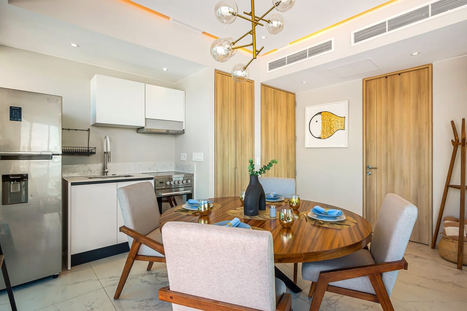 Enjoy meals in a thoughtfully designed dining area connected to a fully equipped kitchen, all framed by spectacular coastal views.