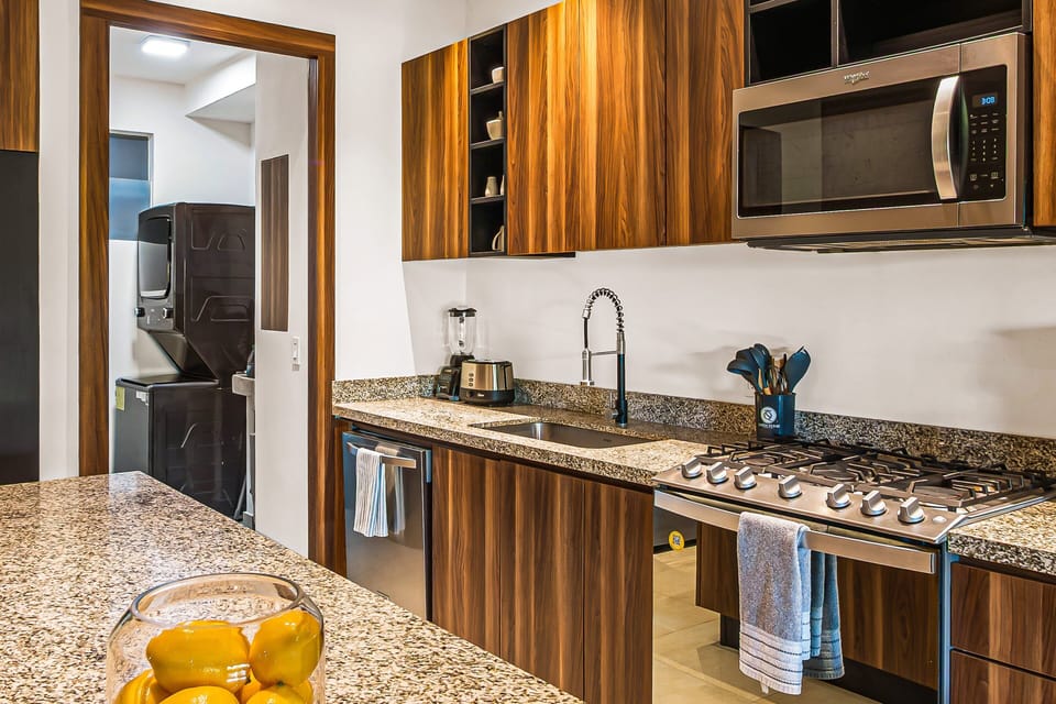 This stylish kitchen offers premium finishes, ample counter space, and everything needed for preparing meals at home.