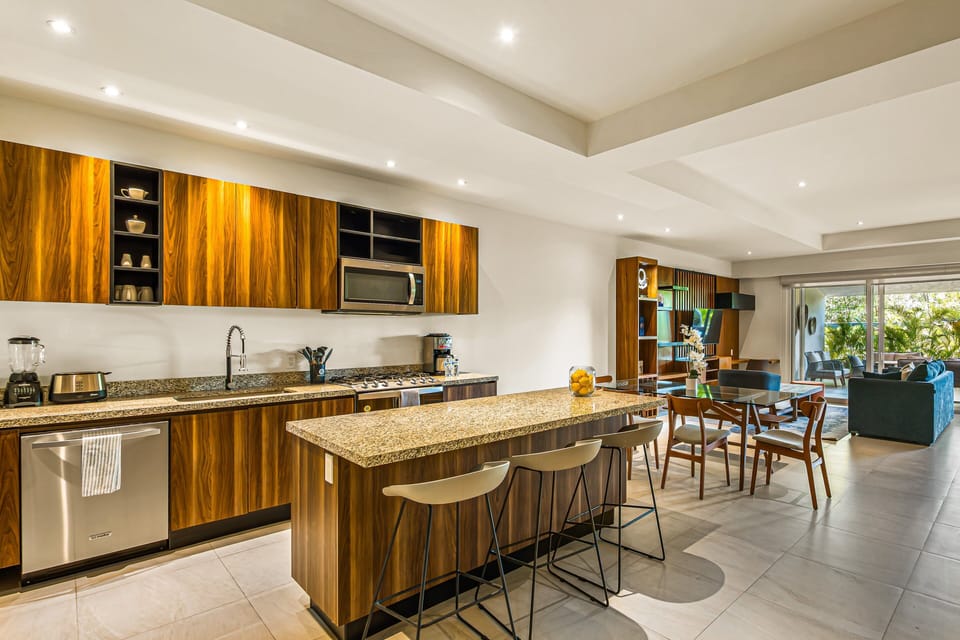 Cook with ease in a spacious kitchen featuring granite countertops, modern appliances, and a large island perfect for gathering.
