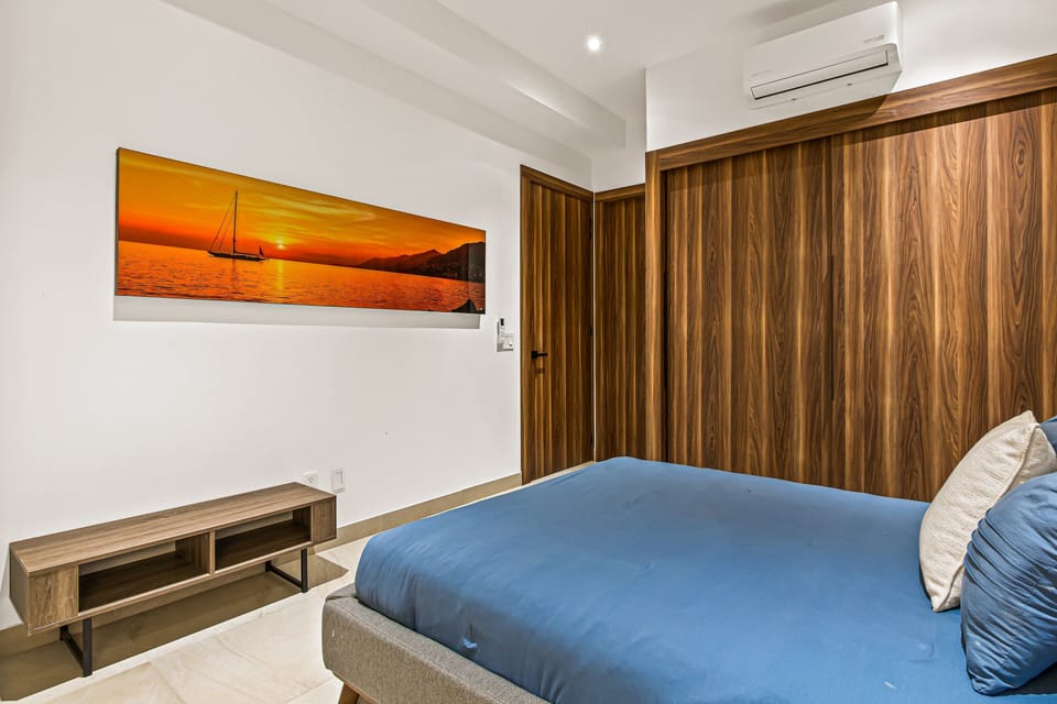 Unwind in a bright and comfortable bedroom featuring plush bedding, ample storage, and a tranquil atmosphere.