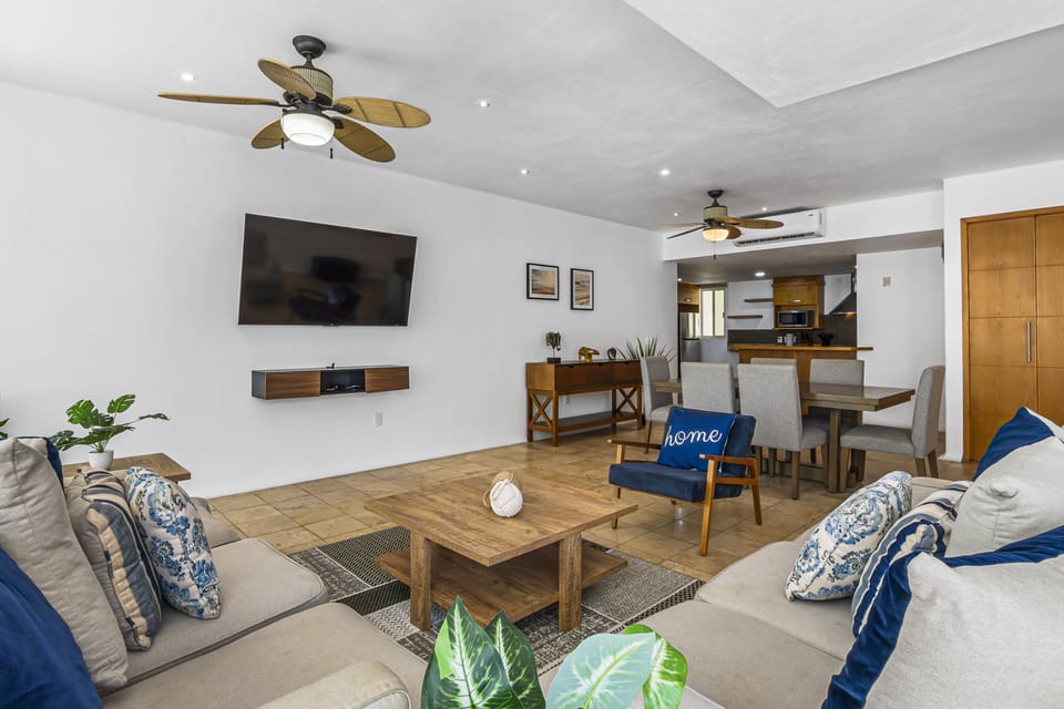 Bright open-concept living area with comfortable seating, Smart TV, and a fully equipped kitchen ideal for relaxing, entertaining, and enjoying your stay.