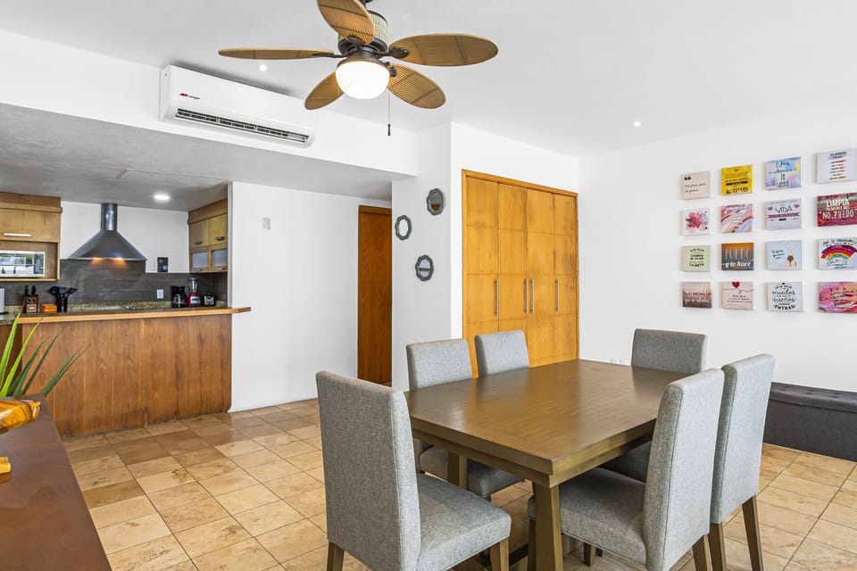 Fully equipped kitchen with breakfast bar and adjacent dining space, designed for convenience and easy meal preparation during your stay.