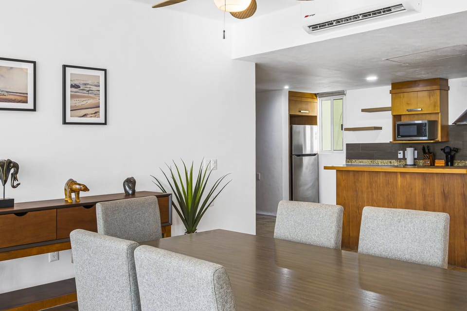 Open layout featuring dining area and fully equipped kitchen with modern appliances and ample space for cooking and entertaining.
