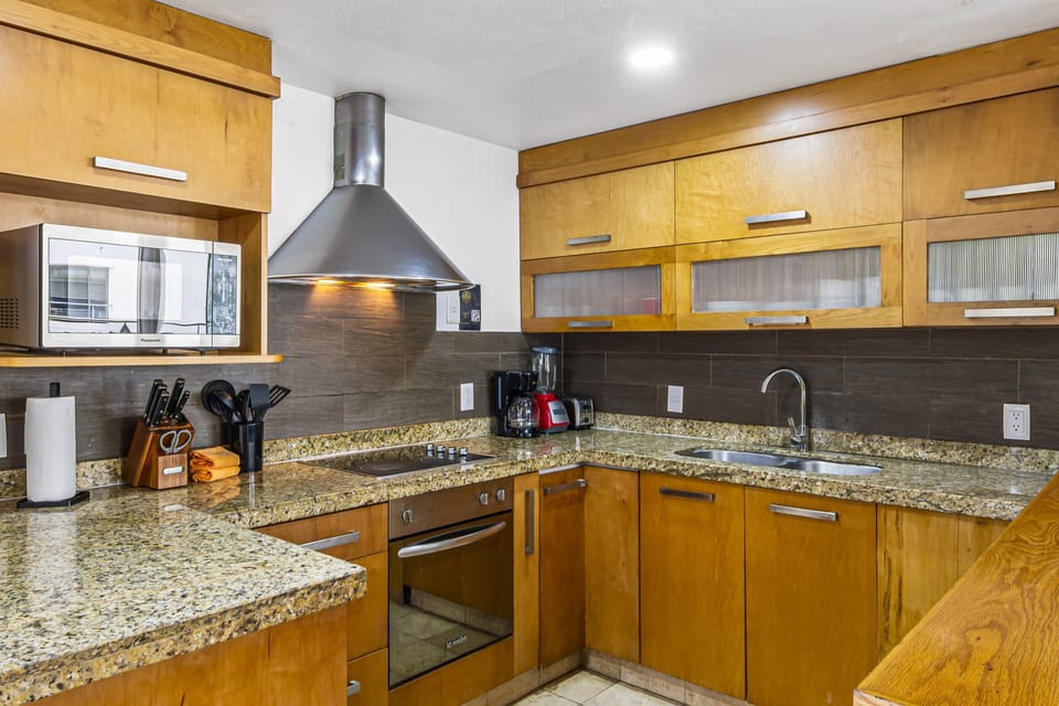 Fully equipped kitchen with granite countertops, modern appliances, and everything you need to prepare meals during your stay.