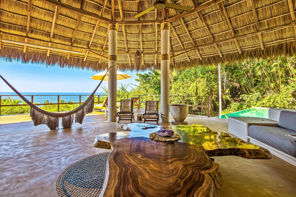 Take in the sea breeze from the shaded lounge with hammocks, cozy seating, and breathtaking views of the Pacific Ocean.