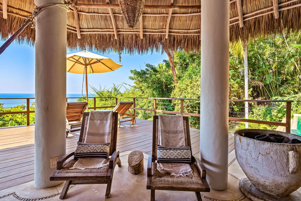 Unwind in the shaded lounge chairs while enjoying panoramic ocean views and the peaceful sounds of the surrounding tropical landscape.