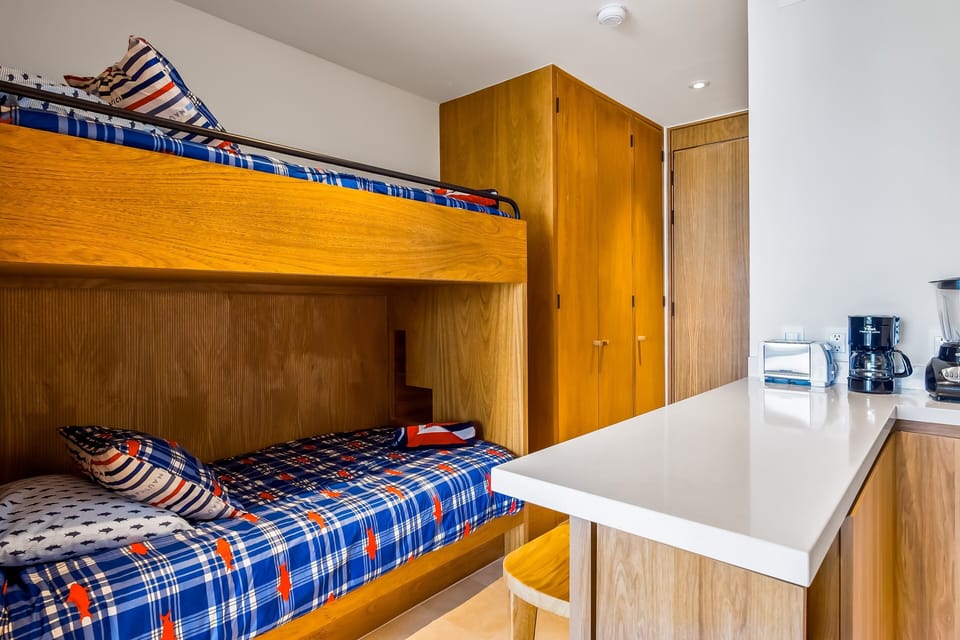 Perfect for families or groups, this custom bunk area offers a comfortable and efficient sleeping arrangement in a stylish setting.