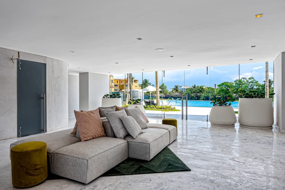 Spacious open-concept common area featuring comfortable seating, abundant natural light, and seamless indoor-outdoor living.