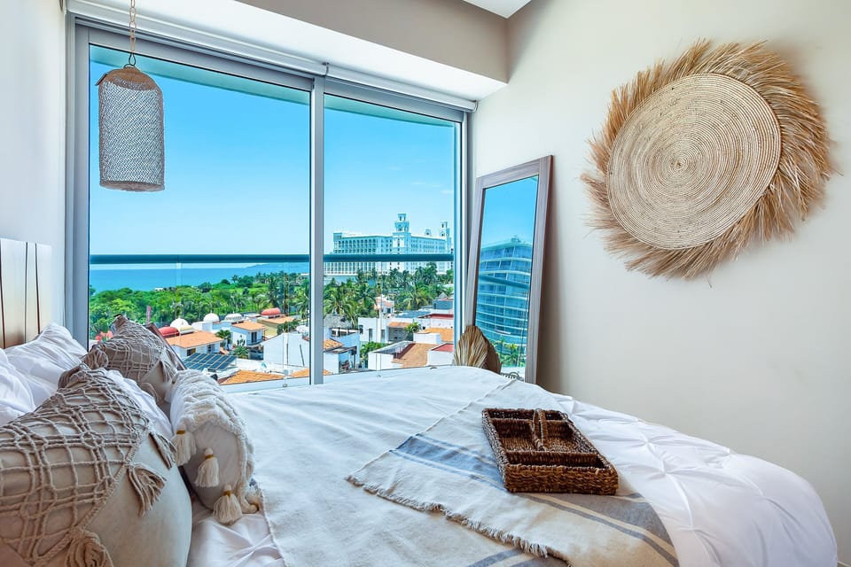 Wake up to stunning bay views from this serene bedroom, featuring floor-to-ceiling windows that fill the space with natural light.