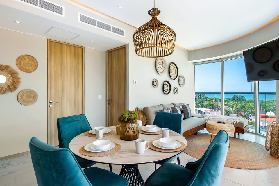 Stunning corner unit with floor-to-ceiling windows showcasing breathtaking ocean, city, and mountain views.
