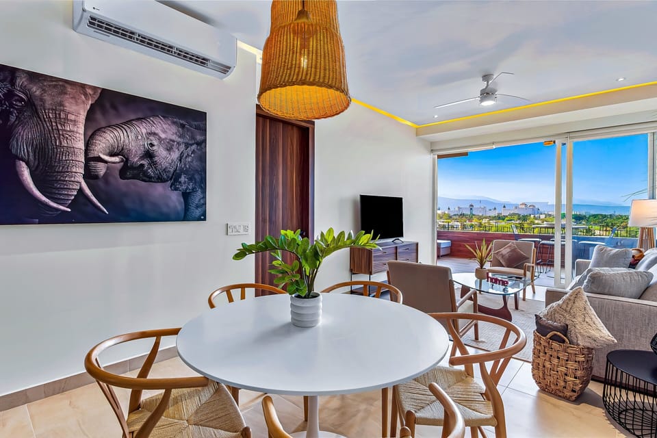 Gather around the dining table and enjoy meals with beautiful natural light, stylish décor, and seamless access to the terrace and panoramic views.