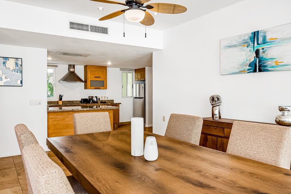 Modern dining area positioned beside the fully equipped kitchen with granite counters and open entertaining layout perfect for group stays.