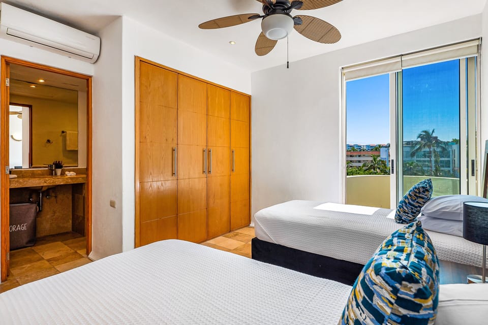 Cozy guest bedroom with two comfortable twin beds, natural light, and a peaceful atmosphere perfect for families, kids, or friends traveling together.