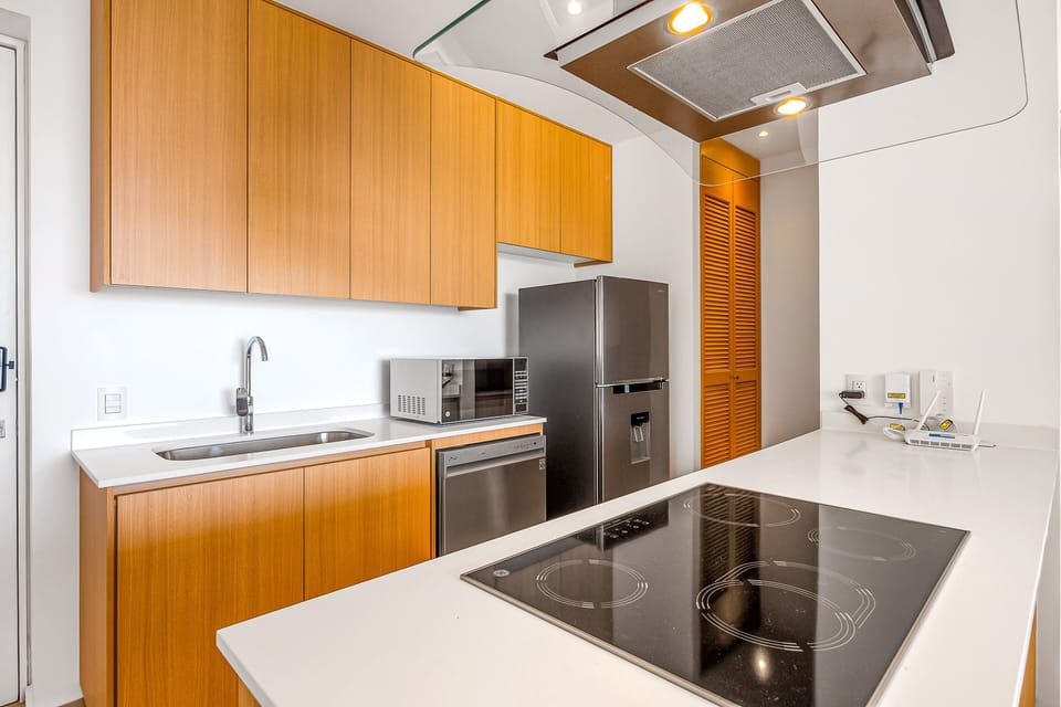 Cook with ease in this modern kitchen featuring premium appliances, ample counter space, and a stylish design perfect for everyday meals or vacation dining.