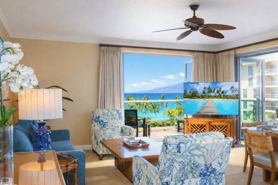 From your living room sofa, you enjoy a direct view of the lanai and ocean beyond, creating a breezy indoor outdoor space for lounging together. HKH-515