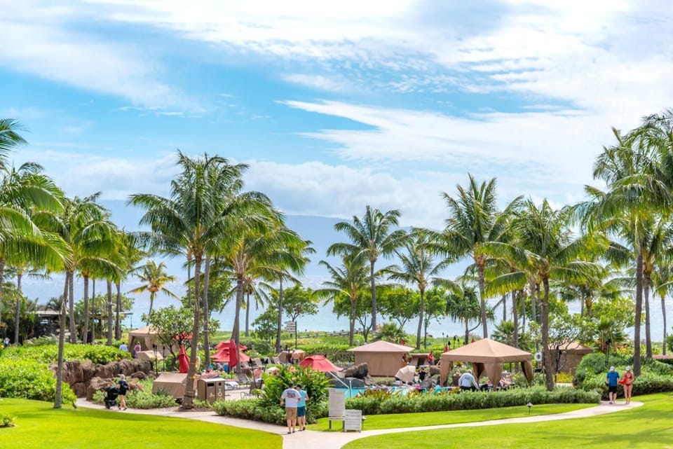 Tropical paradise retreat with palm trees, cabanas, and ocean breeze. HKK-225