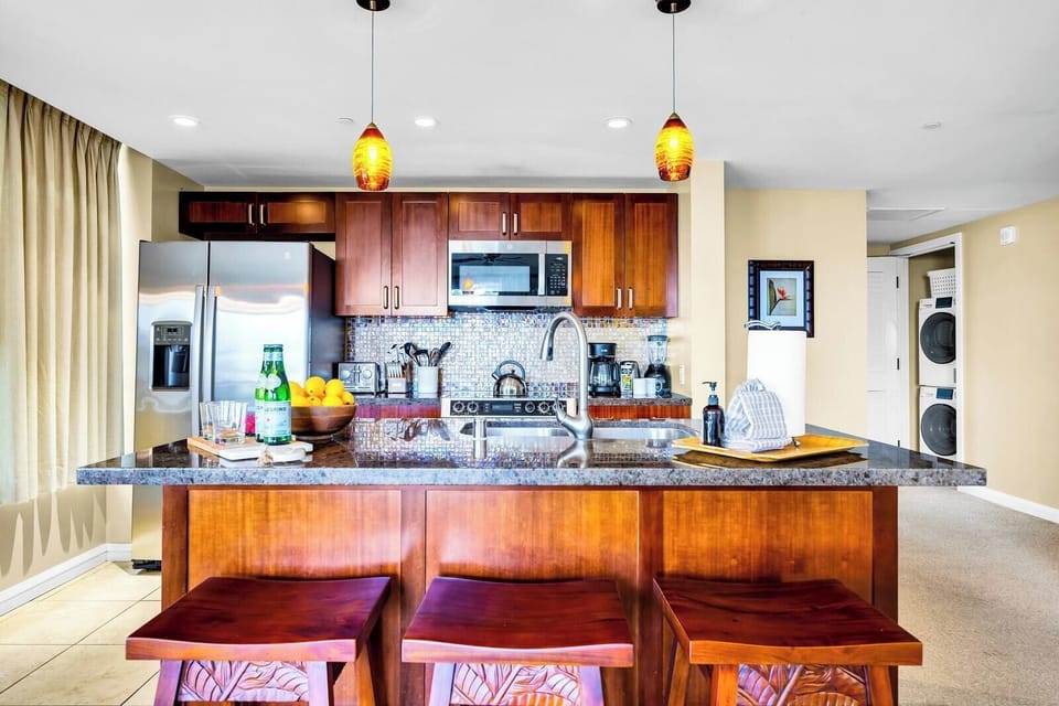 Gather around the kitchen island with bar seating and pendant lighting, a natural hub for breakfasts and happy hour bites. HKK-213