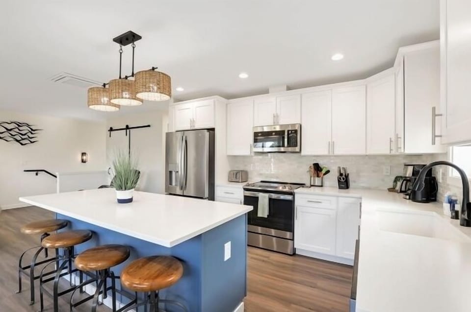 Chef's kitchen with a large island, seating for 4, and full amenities.