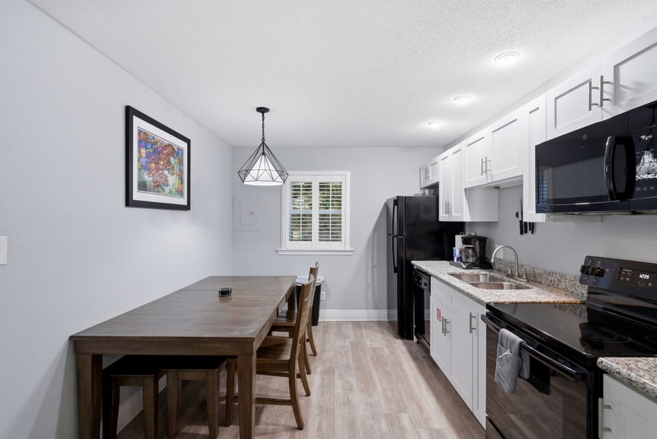 Dining area w/ pendant lighting & a table that seats the whole group.
