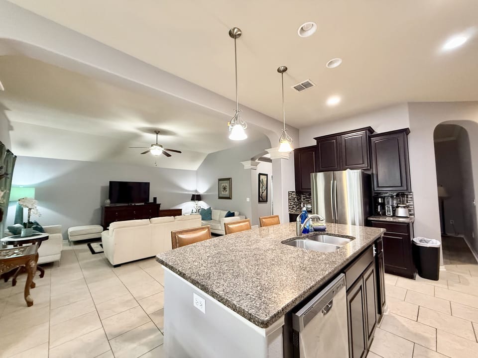 Open kitchen layout with granite countertops and bar seating