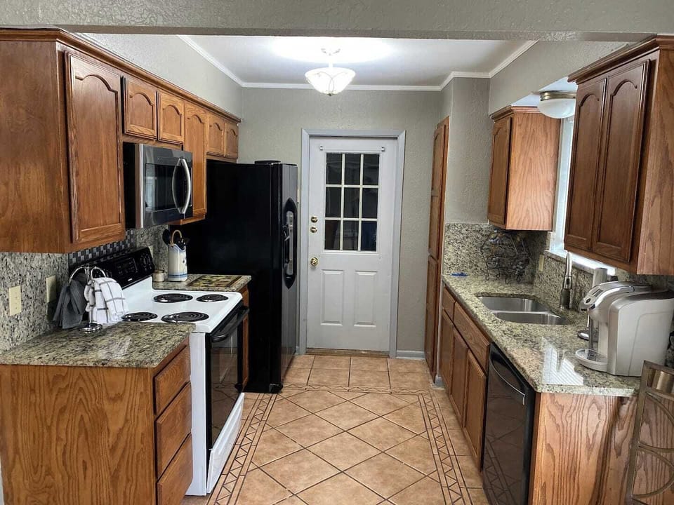 Fully equipped kitchen with modern appliances and generous counter space—perfect for home-cooked meals.