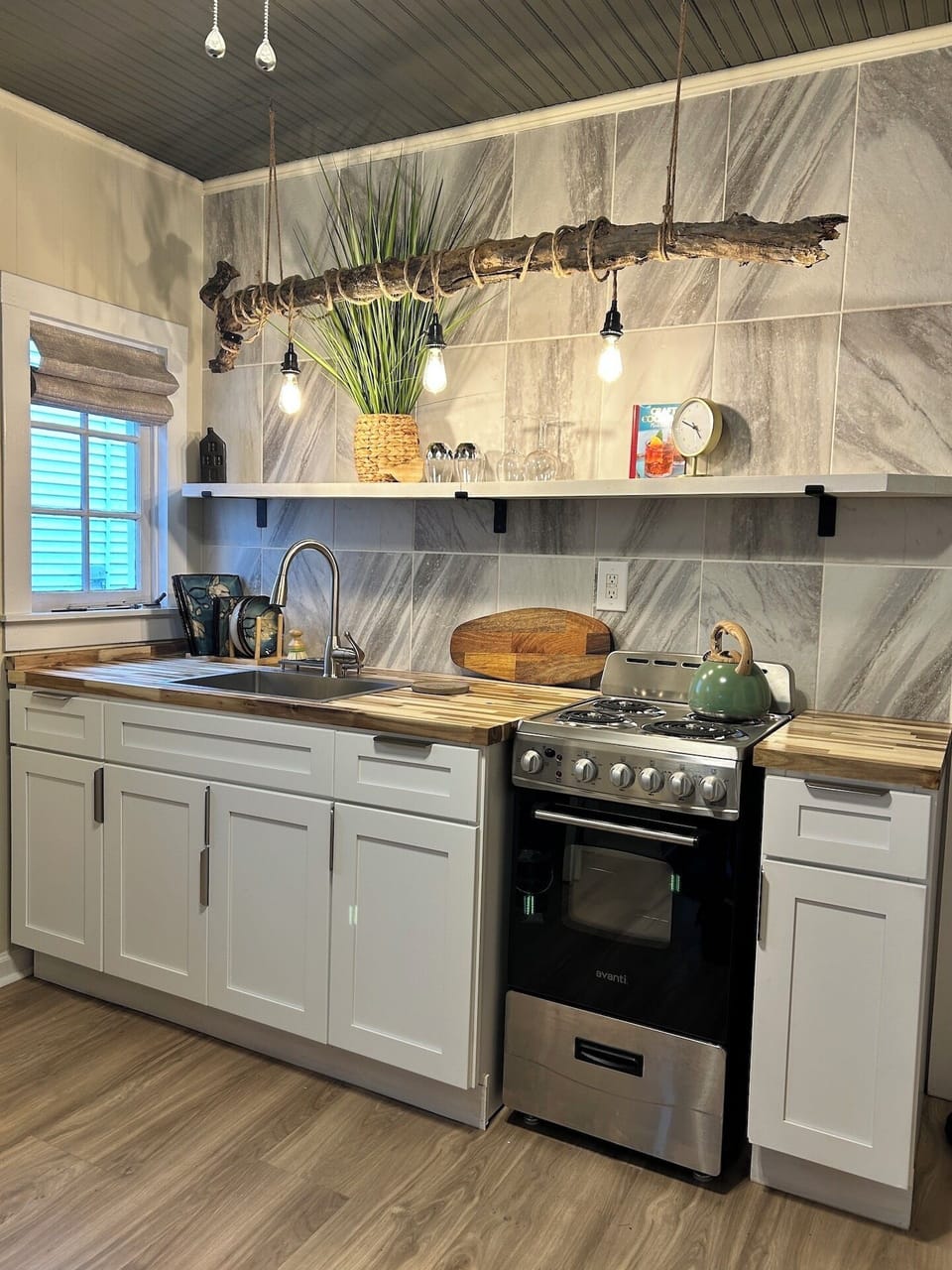 Clean clutter free kitchen with new stainless 20" stove for cooking at home.