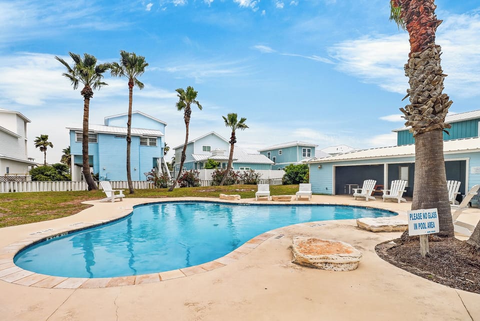 Dive into your private pool oasis surrounded by swaying palms and coastal charm, where sunny afternoons feel endless.