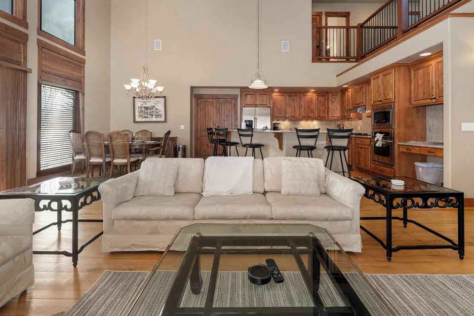 Relax in your spacious open-concept living area with soaring ceilings, rich wood accents, and a chef's kitchen perfect for creating memorable meals together.