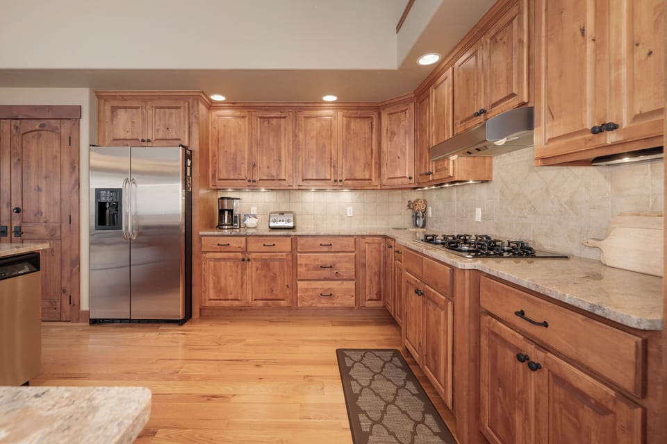 Your spacious kitchen features warm wood cabinets, granite counters, and stainless steel appliances for memorable cooking experiences.