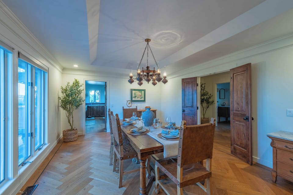 Gather around your elegant dining table where rustic charm meets coastal comfort, perfect for memorable meals together.